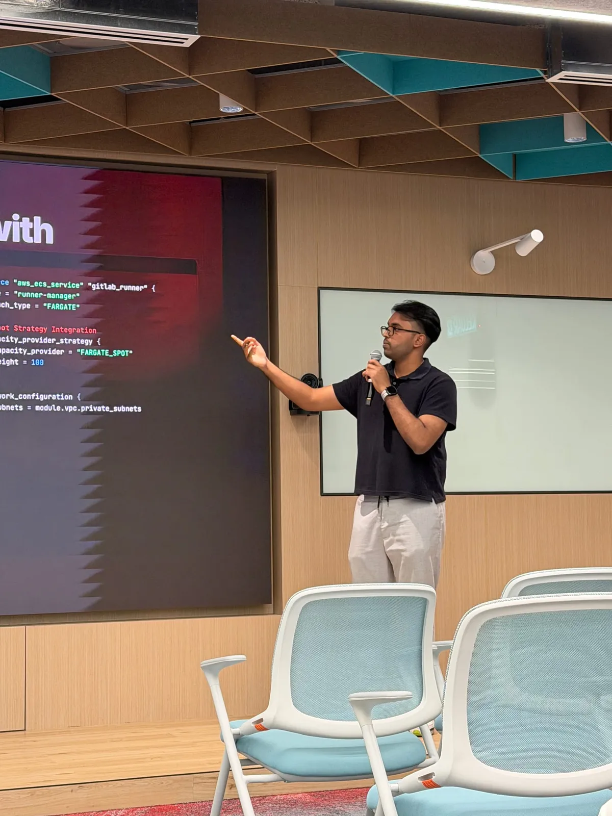 Puvaan Raaj holding a microphone during the Docker Kuala Lumpur session